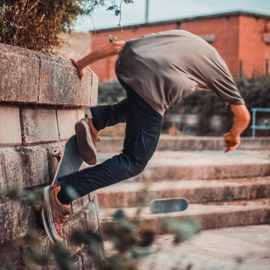 A skateboarder mid trick on steps