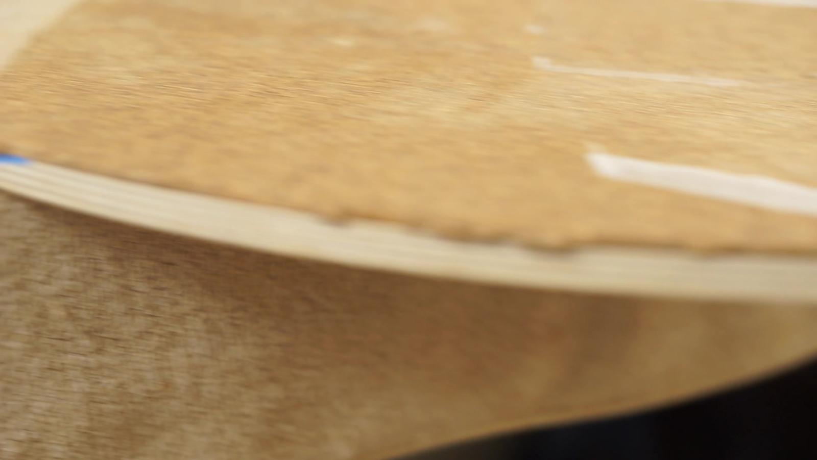 The edge of a Norst board, showing the birch-plywood layers under the cork top deck.