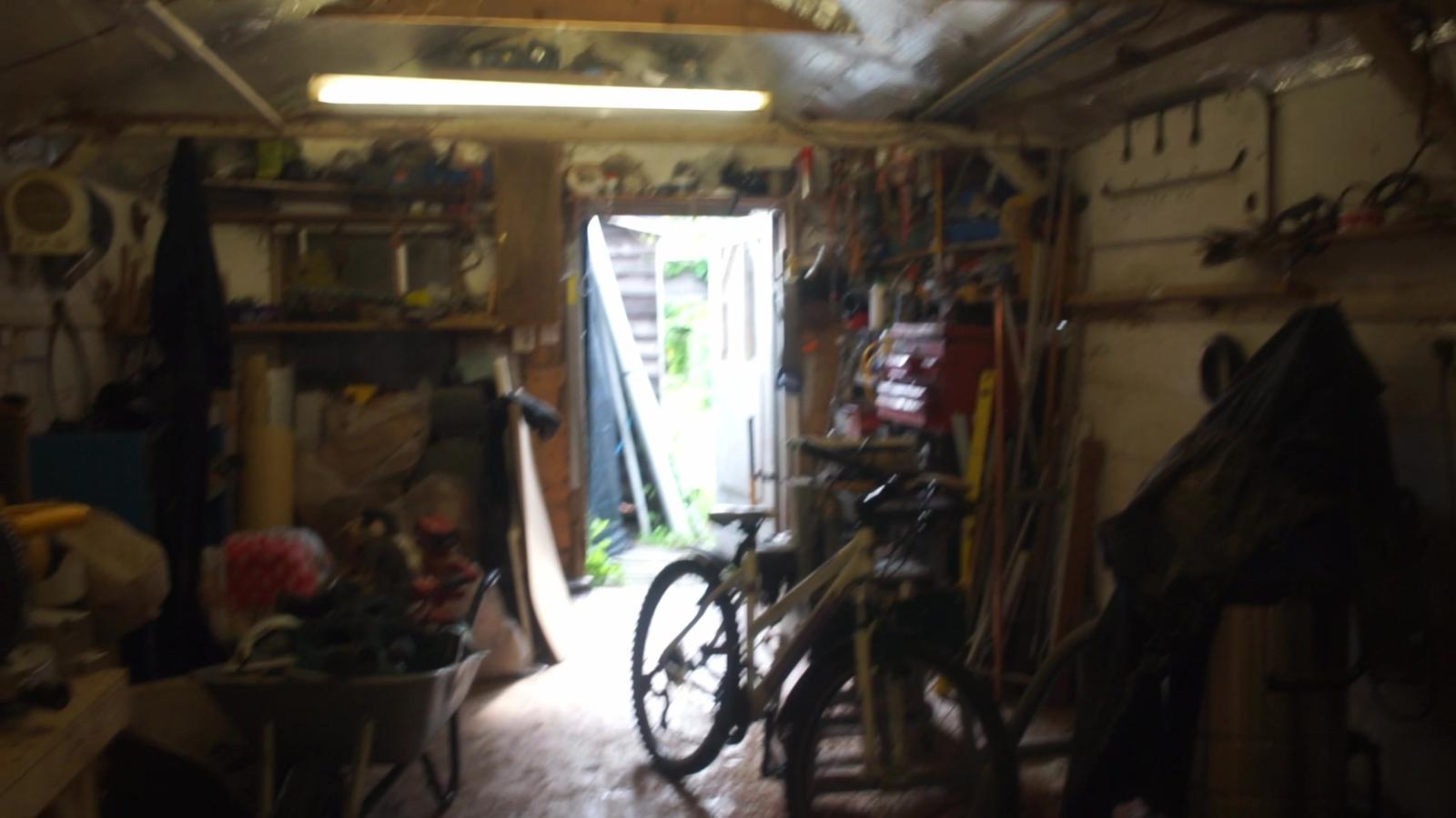 The workshop doorway, with a bike inside and tools on the walls.