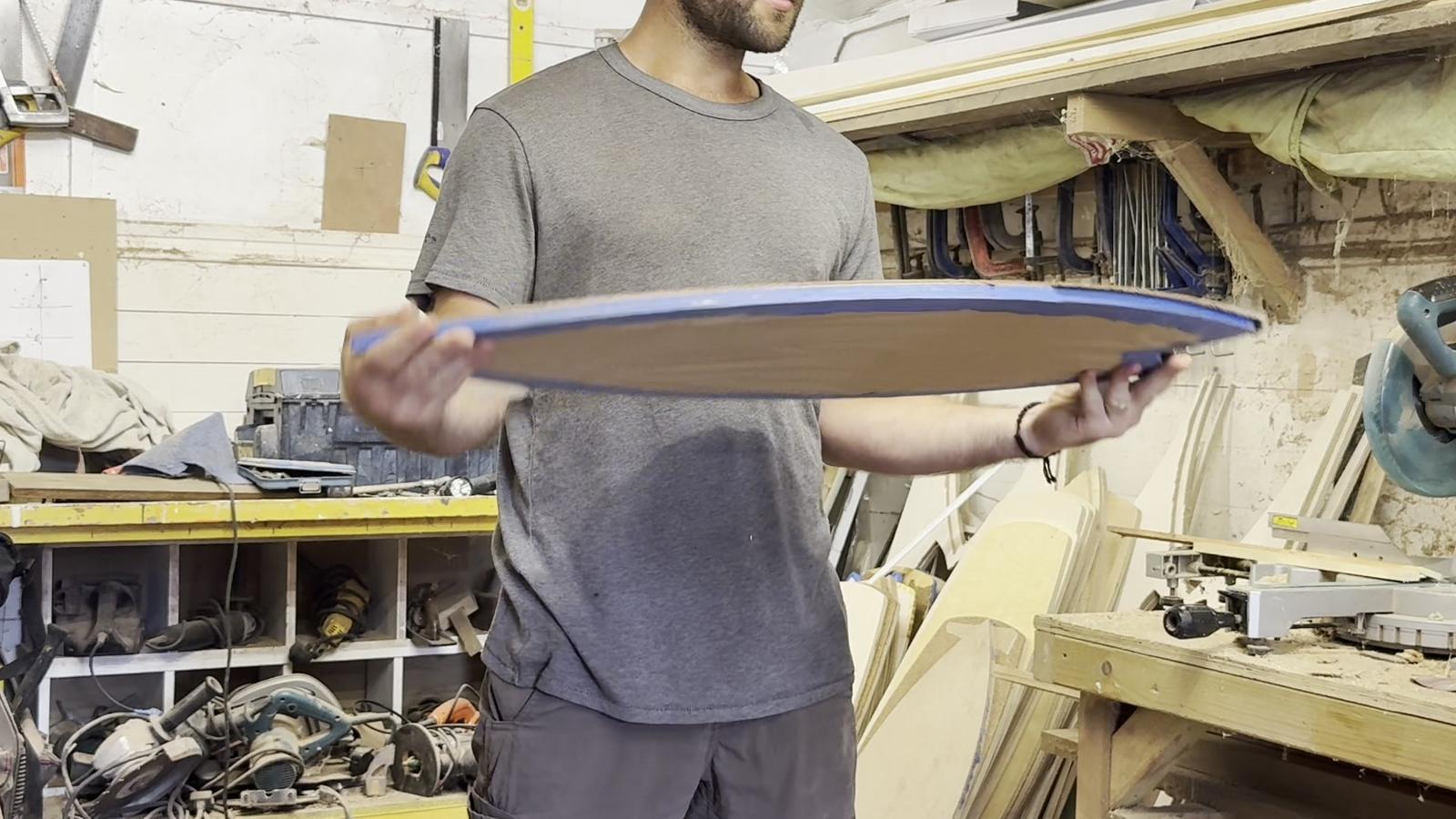 Dan holding a Norst board in the workshop.
