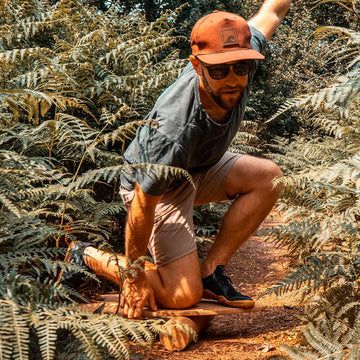 The Norst Surf Balance Board in use on its roller among ferns