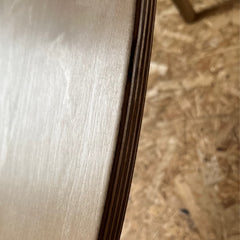 Close-up of a Norst board edge, birch plywood layers under the cork deck