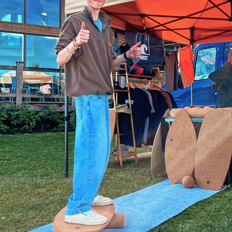 Someone stepping onto a Norst board at a Norst stall.